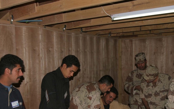 Two Soldiers get their ballots from poll workers