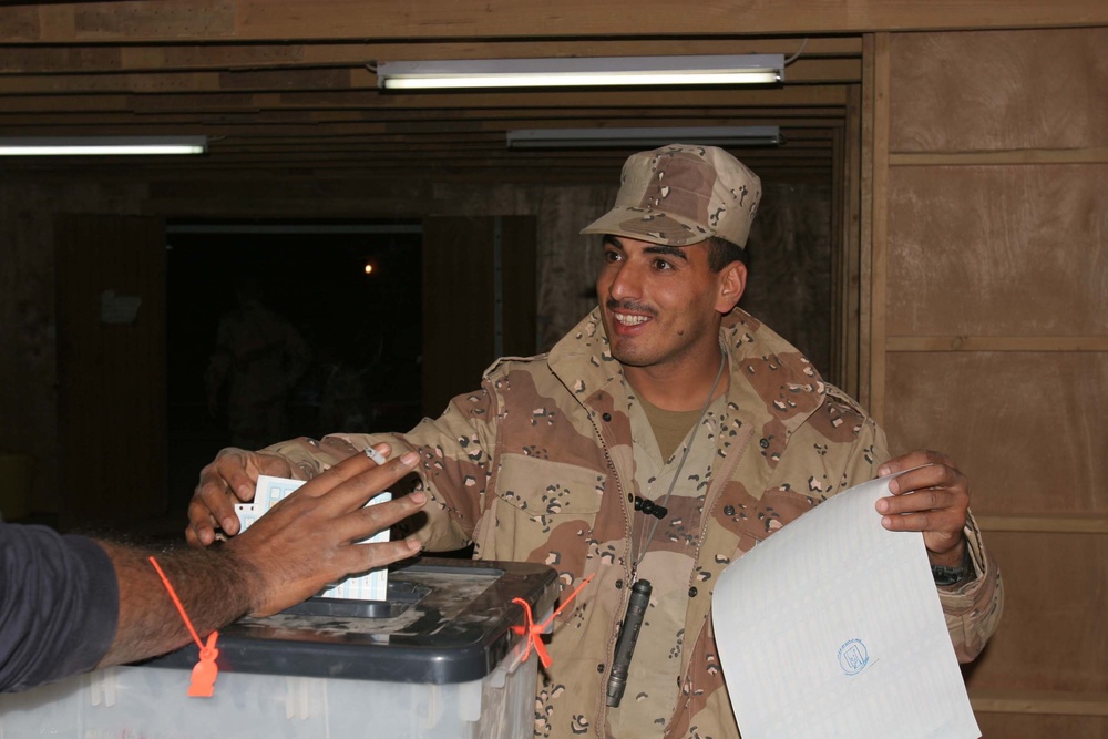 A Soldier drops a ballot in the ballot box