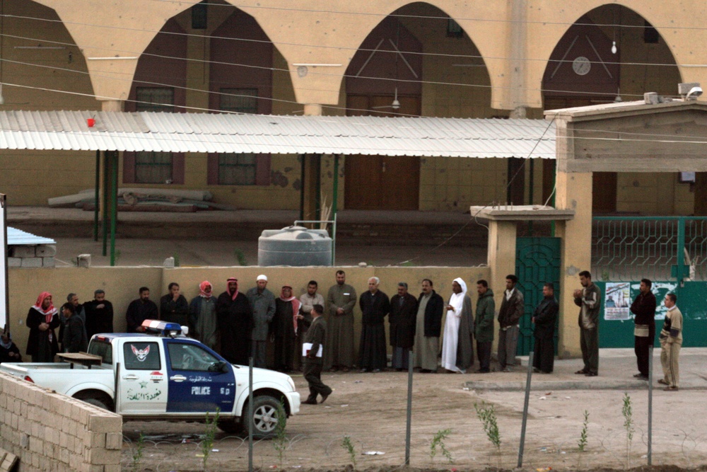 Citizens of Fallujah stand at a polling site