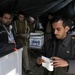 An Iraqi man folds his ballot