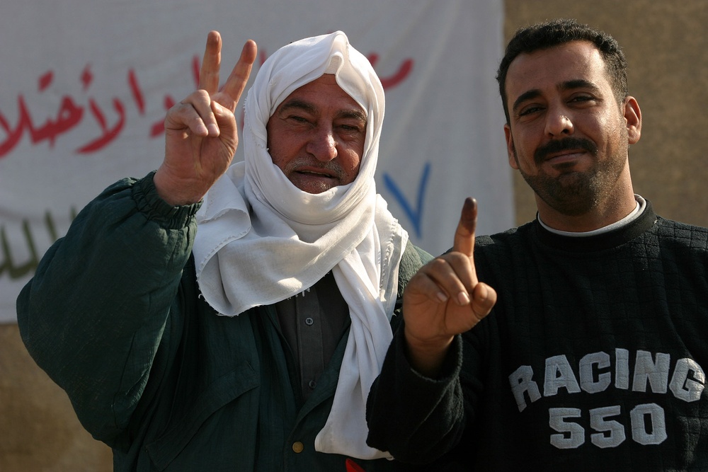 Two local men proudly display their purple fingers