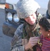 Maj. Thompson takes time out to hand candy to kids