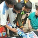 Master Sgt. Elmore hands out toy cars to young Iraqi boys
