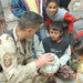 Master Sgt. Bonnar discusses soccer with a young Iraqi boy
