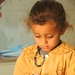 Dr. Guliuzza uses an otoscope to put a young Iraqi patient at ease
