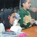 Two young Iraqi children receive free school supplies and toys