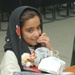 A young Iraqi girl receives free school supplies and toys