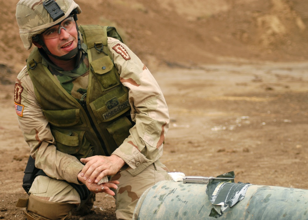 Sgt. 1st Class Morrison packs a one thousand pound bomb with plastic explos