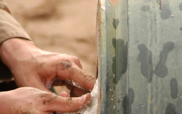 Sgt. 1st Class Morrison packs a one thousand pound bomb with plastic explos