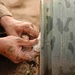 Sgt. 1st Class Morrison packs a one thousand pound bomb with plastic explos