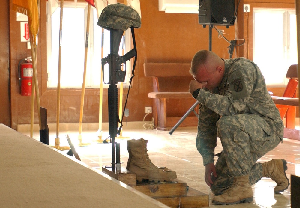 Capt. Timothy Bean pays his respect to Sgt. 1st Class James S. Moudy