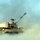 A M-109A6 Paladin is engulfed in dust, sand and smoke
