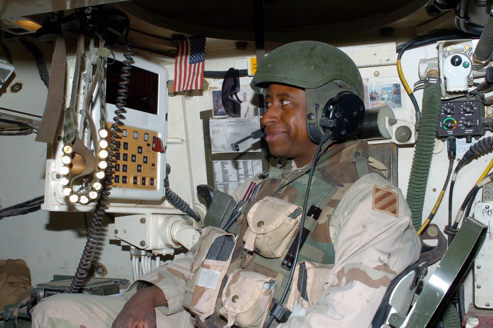 Staff Sgt. Neal sits inside a M-109A6 Paladin