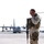 Master Sgt. McGilvray stands guard in front of an Iraqi C-130 Hercules