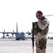 Master Sgt. McGilvray stands guard in front of an Iraqi C-130 Hercules