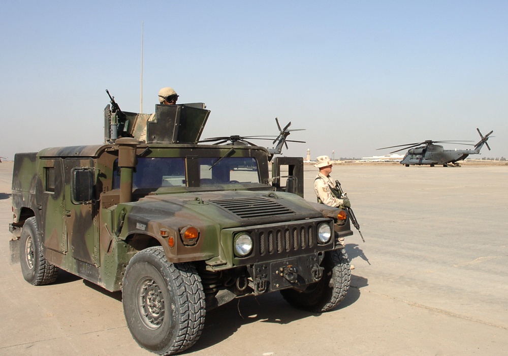 A patrolman guards two MH-53 Pave Low helicopters on Christmas Eve