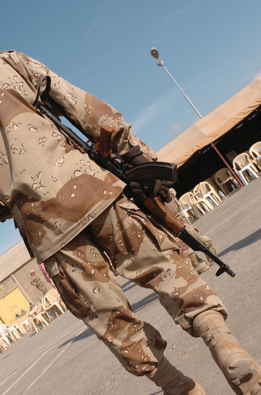 An Iraqi Soldier Walks Across the Deserted Parade Field