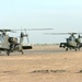 Two AH-64 Apaches taxi down the runway