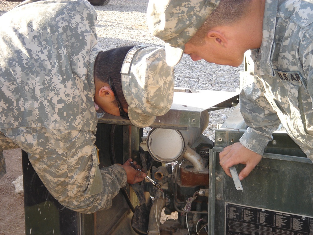 Soldiers change the thermostat on a five-kilowatt generator