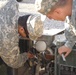 Soldiers change the thermostat on a five-kilowatt generator