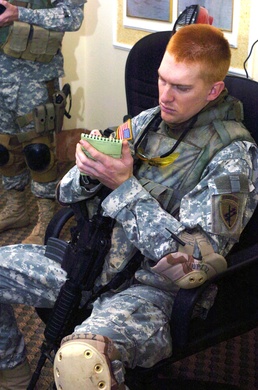 Cpl. Kupitz writes detailed notes during a meeting