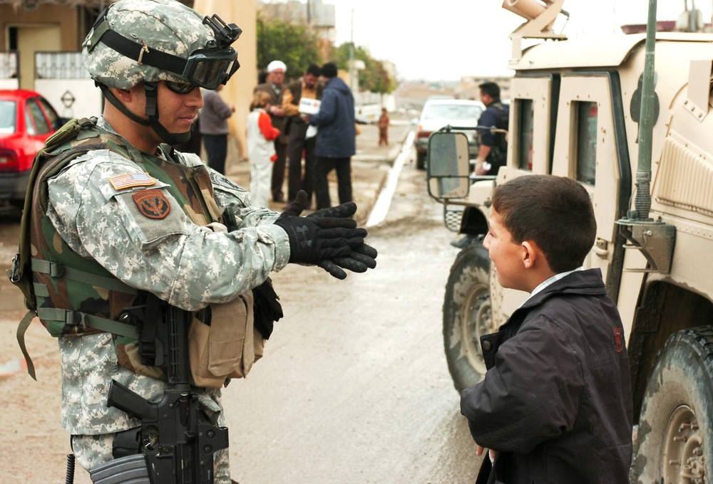 Staff Sgt. Betancourt speaks with an Iraqi youth