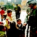 Sgt. Warren shakes hands and jokes with some Iraqi children