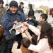 An Iraqi police officer hands out candy and toys to children