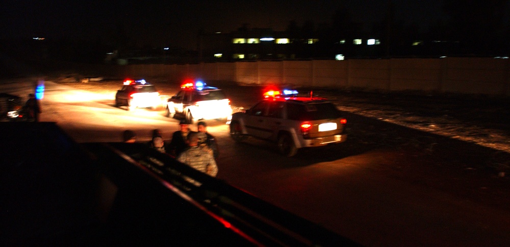 Iraqi Police vehicles line up for a night raid