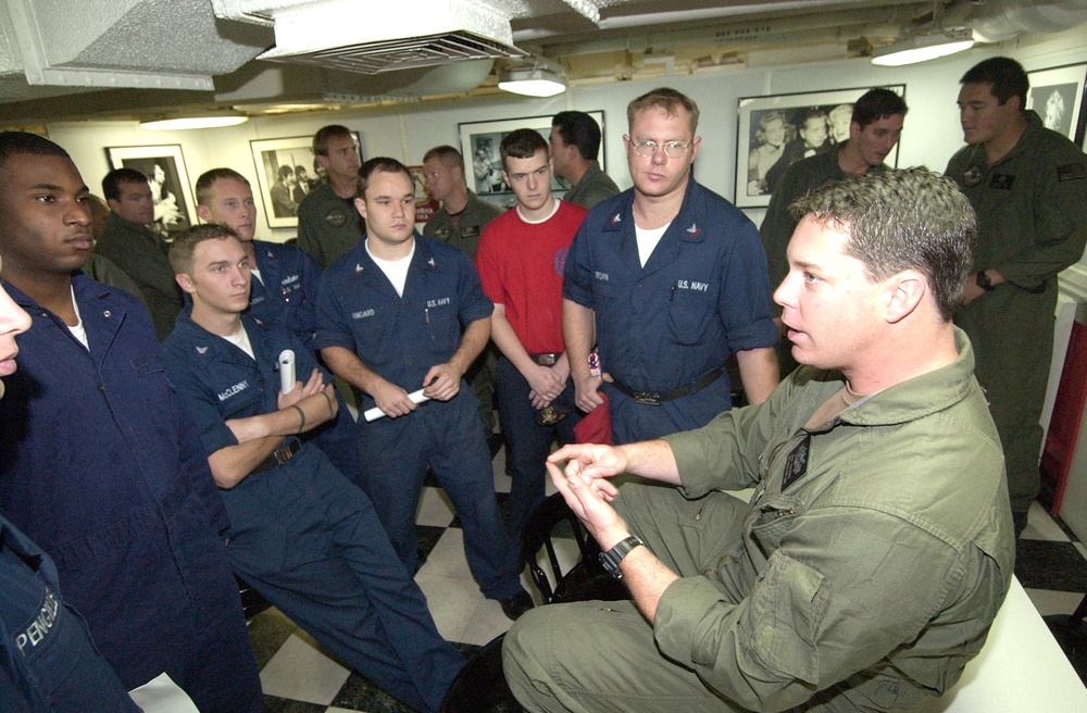 Shipmates gather around QM1  Raymond