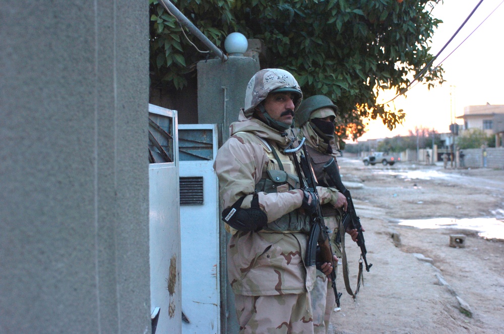 Iraqi Army Soldiers pull security during a cordon and search