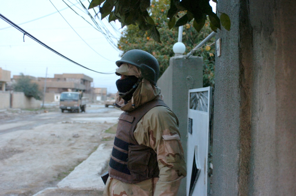 An Iraqi Army Soldier pull security during a cordon and search