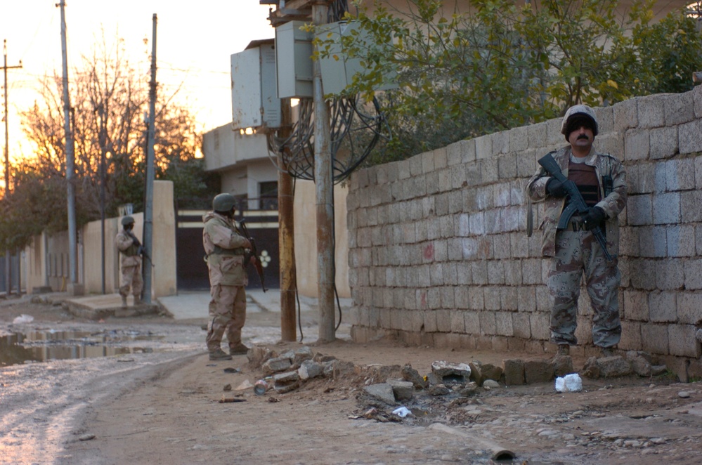 Iraqi Army Soldiers pull security during a cordon and search