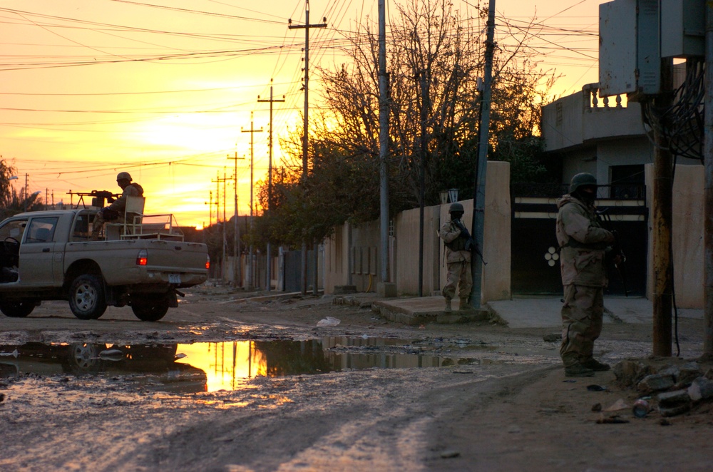 Iraqi Army Soldiers pull security during a cordon and search