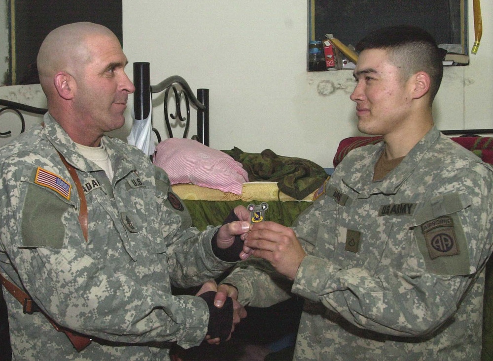 Sgt. Maj. Adams Receives a Fort Suse Coin From His Son