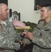 Sgt. Maj. Adams Receives a Fort Suse Coin From His Son