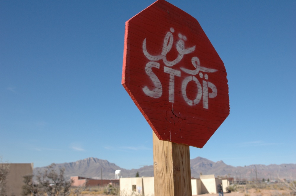 A stop sign, painted in both Arabic and English