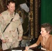 Laura Ingraham Autographs a Photo for Spc. Cockes