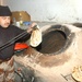 An Iraqi Army cook prepares bread for dinner