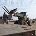 Soldiers load concrete barriers