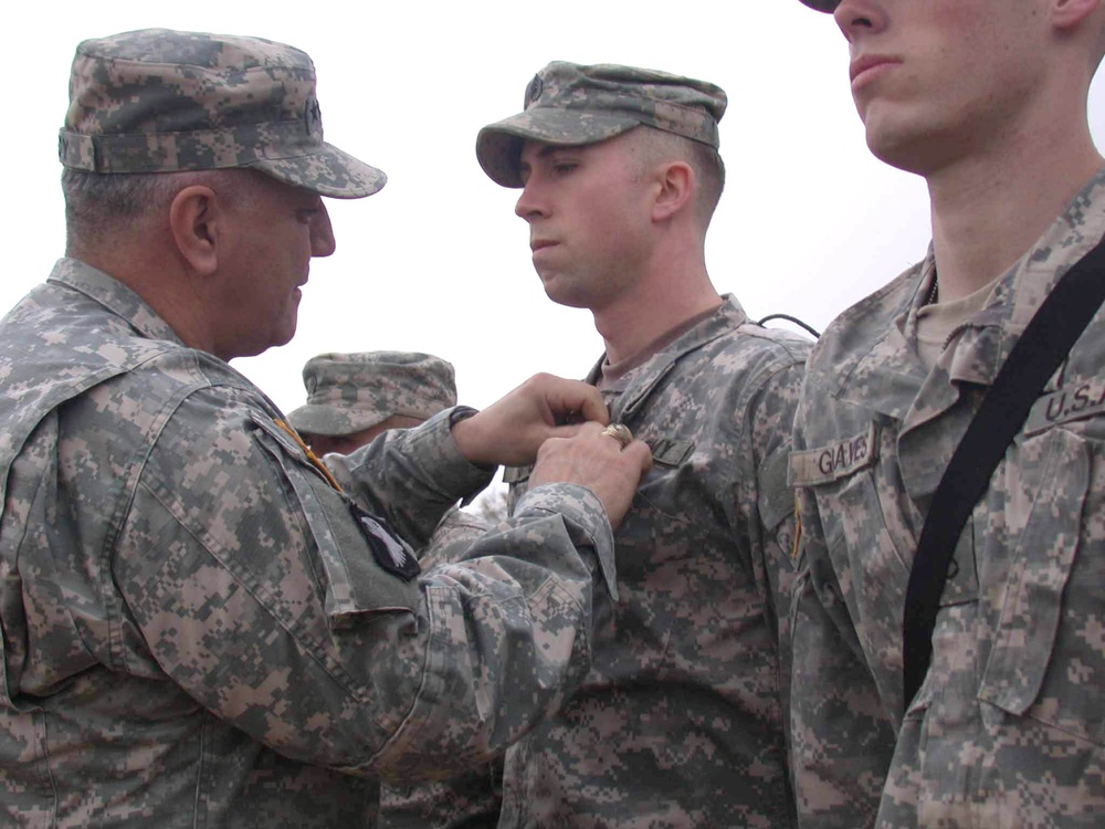 Gen. Cody pins a Purple Heart on Sgt. Gang