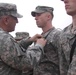 Gen. Cody pins a Purple Heart on Sgt. Gang