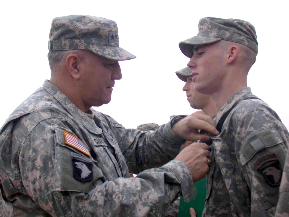 Gen. Cody pins a Purple Heart on Pfc. Graves