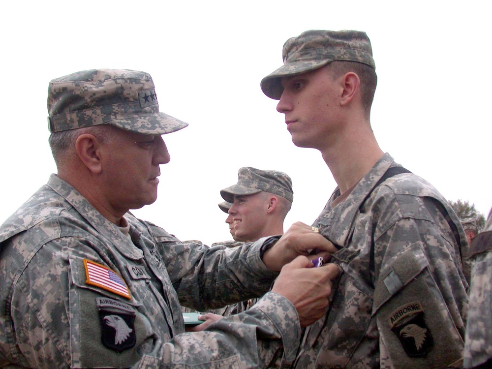 Gen. Cody Pins a  Purple Heart Medal on Pfc. Daniel Wilson
