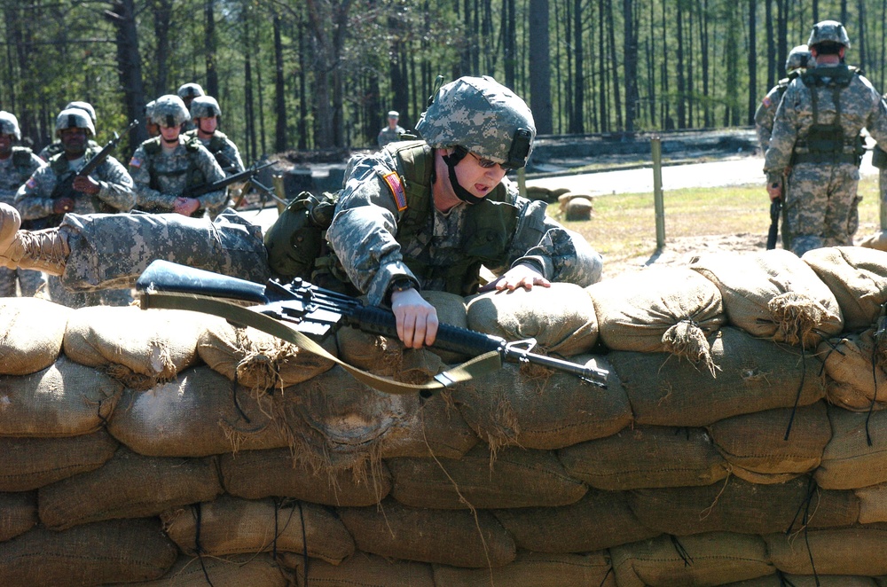 Staff Sgt. Positions Herself to Jump Over a Sandbag Wall