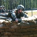Staff Sgt. Positions Herself to Jump Over a Sandbag Wall