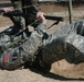 Sgt. 1st Class Mckenzie Crawls Under a Barbed Wire Obstacle