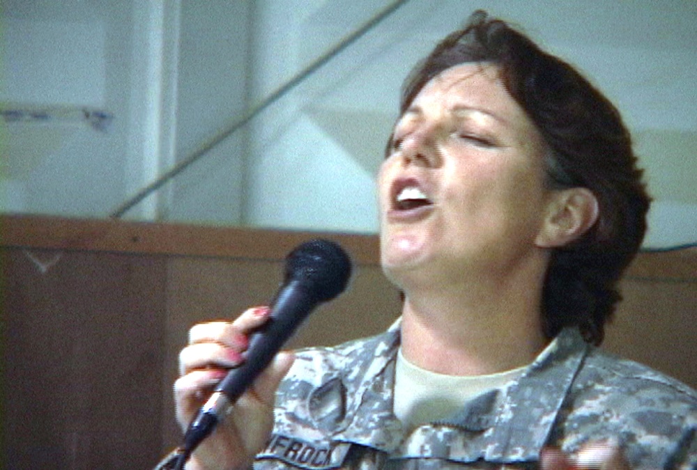 Staff Sgt. Newfrock hits a high note while  singing a song
