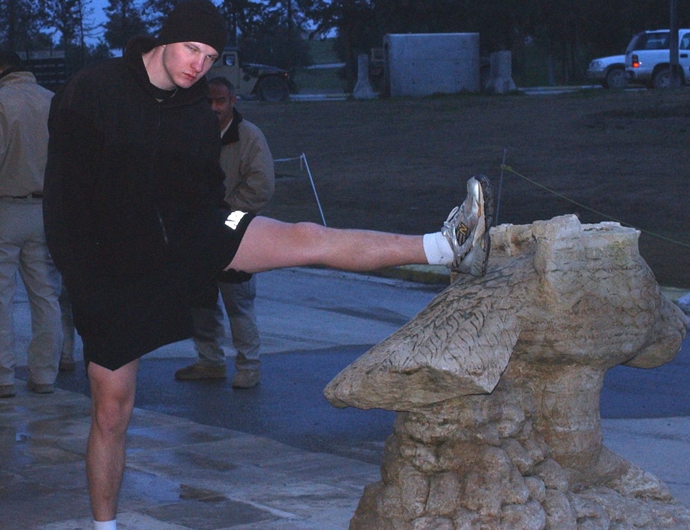 A Soldier stretches before a 5K run