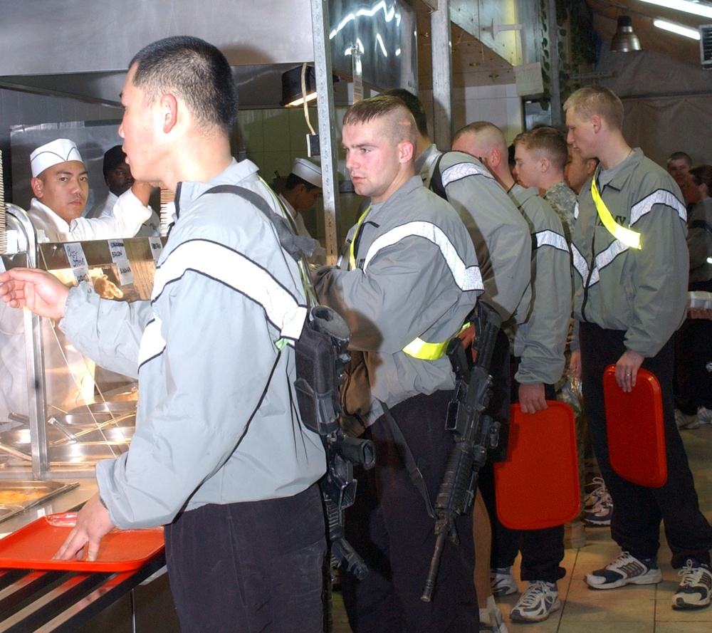 Soldiers wait in line for breakfast